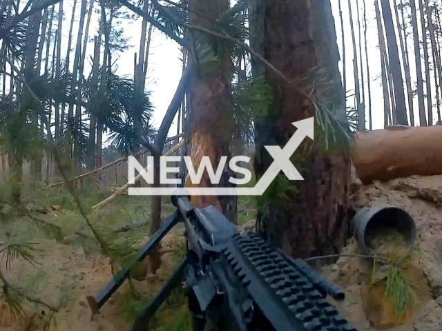 Russian troops in close combat shoot out in the woods with the Ukrainian fighters in Ukraine in undated footage. The footage was released by Russian MoD on Wednesday, May, 10, 2023.Note: Picture is screenshot from a video. (Ministry of Defense of Russia/Newsflash)