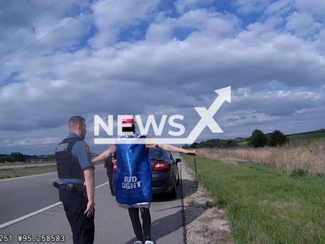 A man dressed as a Bud Light beer is examined by a police officer, in Franklin County, Kansas, USA, undated.   The driver was  placed under arrest for driving under the influence of alcohol and transported to jail. Note: Police photo. (Franklin County, KS - Sheriff's Office/Newsflash)