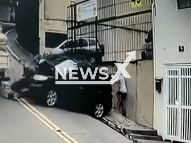 A man escapes being  crushed into a wall by a car hut by a runaway lorry, in Sao Paulo, Brazil, on Wednesday, May 10, 2023. The lorry driver required medical attention and was taken to the hospital. Note: Picture is screenshot from a video. (Newsflash)