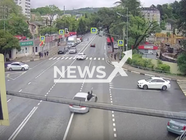 Unnamed driver, 36, of Nissan car drifts with passenger climbing out the window in a residential area of Sochi, Russia, undated. Traffic police detained the driver. Note: Picture is a screenshot from a video (@gibddsochi/Newsflash)