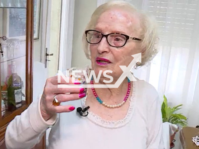 Esperanza Cortinas, 106, holds a glass with coffee liqueur, undated. She claims the secret of her longevity is a daily shot of coffee liqueur. Note: Photo is a screenshot of video. (Newsflash)