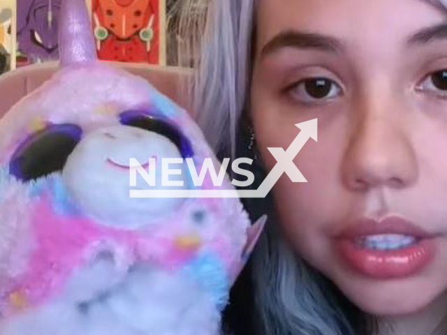 Kine-chan vented poses with  cuddly toy with a hidden camera found inside  sent by a fan, undated. She is an OnlyFans model and is selling candles with the scent of her private parts.
  
 Note: Photo is a screenshot from a video. (Newsflash)