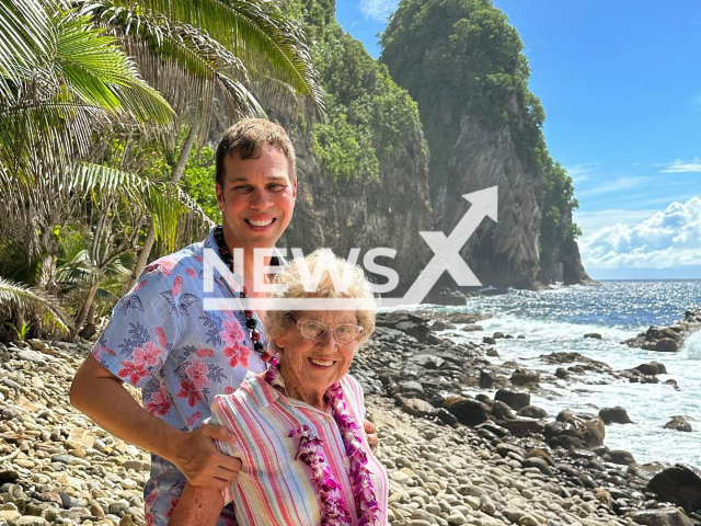 Joy Ryan, 93, and her grandson, Brad Ryan, pose at the National Park of American Samoa, undated photo. Joy and Brad have visited all 63 National Parks in the United States. Note: Private photo. (@grandmajoysroadtrip/Newsflash)