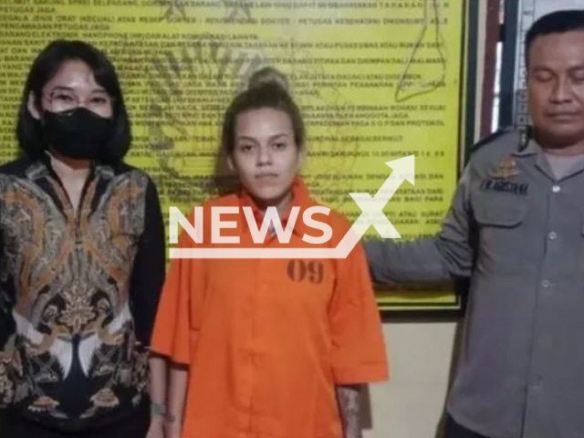 Manuela Vitoria de Araujo Farias, 19, poses with a woman and a police officer in an undated photo. Manuela was indicted for drug trafficking on the island of Bali, Indonesia, on Friday, Jan. 27, 2023. Note: Photo from police (Bali Police/Newsflash)