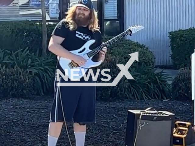 Man in California protests dental office with guitar solo outside. Note: Picture is a screenshot from a video (@ferngalvn/Newsflash)