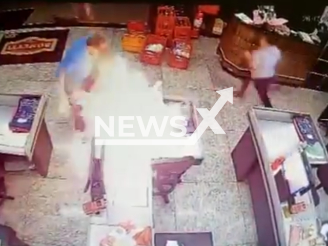 Description: A man sets fire to a supermarket cash register after being accused of theft in Santo Antonio de Posse, Brazil, Friday, May 27, 2023. The man was detained by market officials until the arrival of the Municipal Civil Guard. Notes: Photo is  screen from the video.(Newsflash)