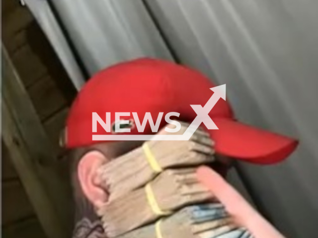 Picture shows one of the suspects boasting with money, undated. Police arrested 33 suspects in Santa Catarina and Rio Grande do Sul. Note: Private photo. (Newsflash)